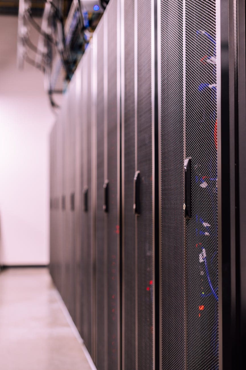 Server racks under cool light, the substrate of connected systems.