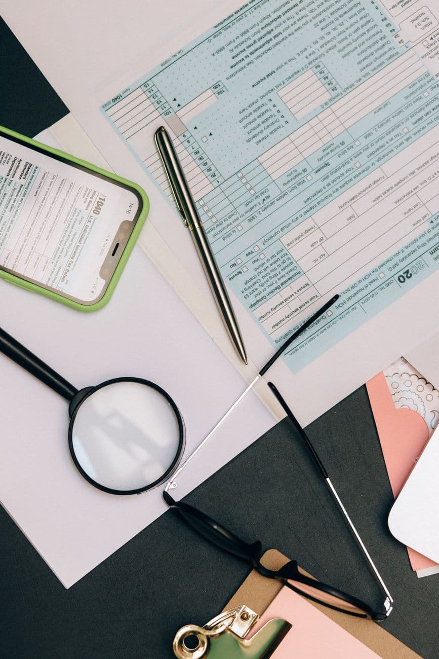A desk strewn with paper, the texture of operational admin.